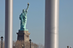 the liberty statue seen behind the bars
